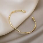 A Sleek And Stylish Twisted Texture Golden Bangle - Image 3