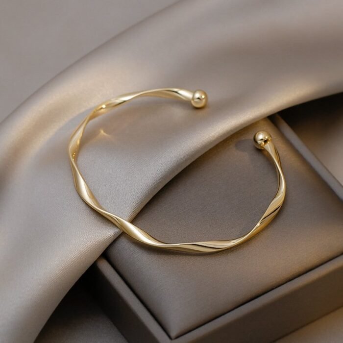 A Sleek And Stylish Twisted Texture Golden Bangle - Image 1