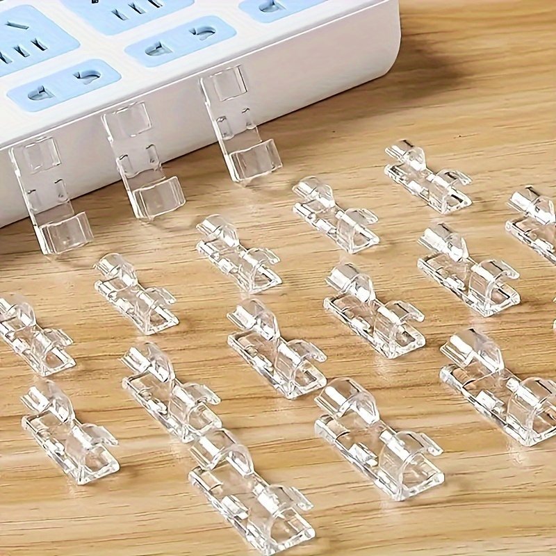 product-fancy-8b217834-d3ec-4d36-a90e-f7e2fa07f175.jpg 100Pcs Adhesive Cable Clamps, Transparent Wire Brackets For Power Line Management, Plastic Cable Tissue Clamps For Walls And Under Tables - Image 1